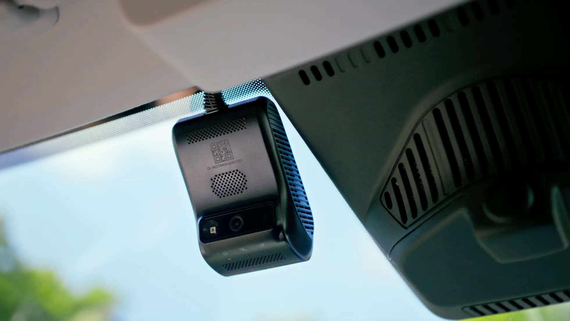 Compact black 4G fleet dash cam mounted on a vehicle windscreen next to the rear-view mirror housing